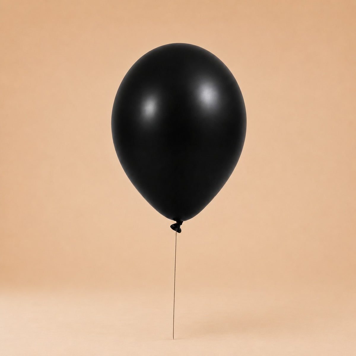 Black helium balloon add-on, tied to a Bloomistry flower arrangement