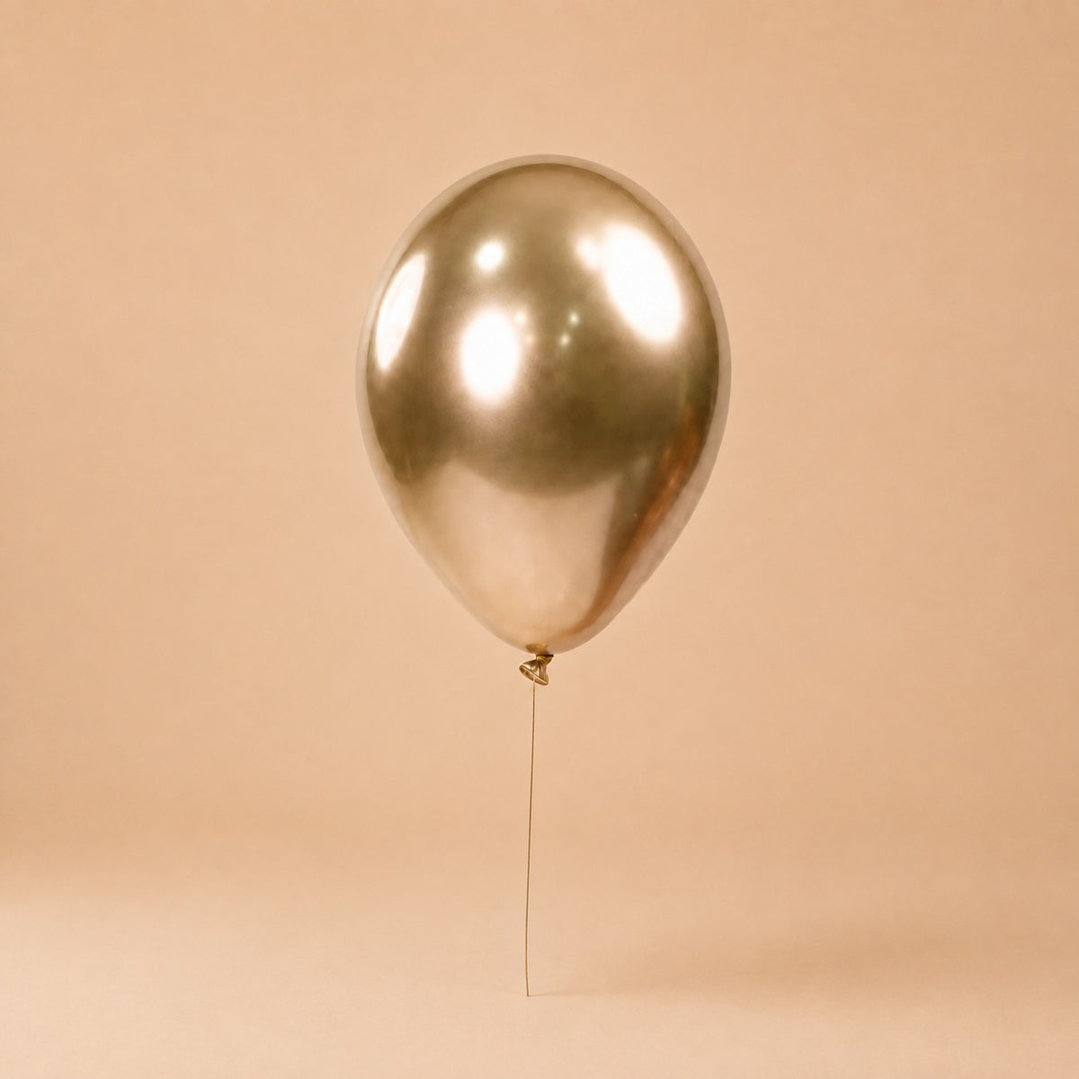Gold helium balloon add-on, tied to a Bloomistry flower arrangement