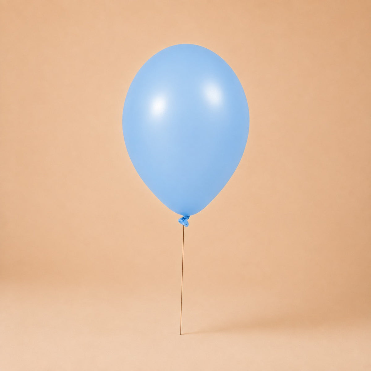 Light blue helium balloon add-on, tied to a Bloomistry flower arrangement