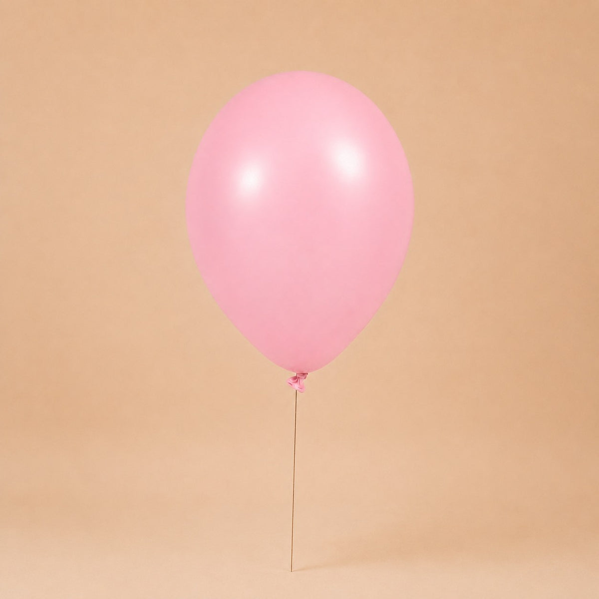 Pink helium balloon add-on, tied to a Bloomistry flower arrangement