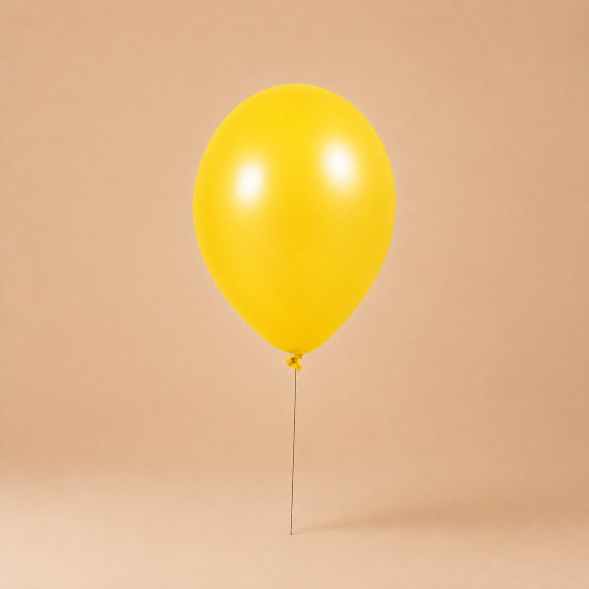 Yellow helium balloon add-on, tied to a Bloomistry flower arrangement