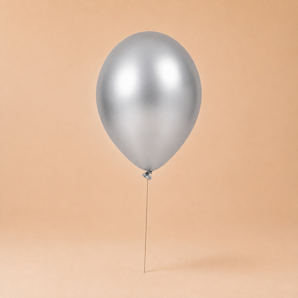 Silver helium balloon add-on, tied to a Bloomistry flower arrangement